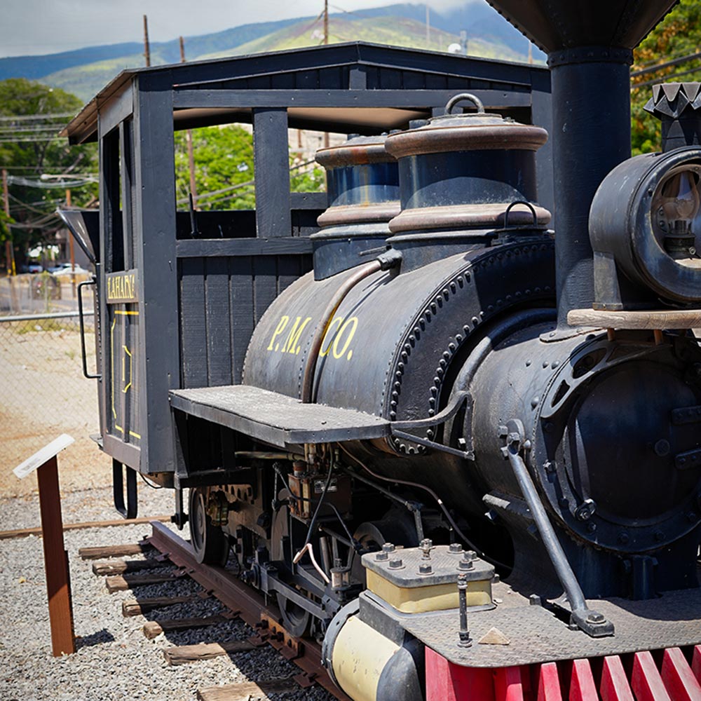 image of historic smokestack and trains in Lahaina.